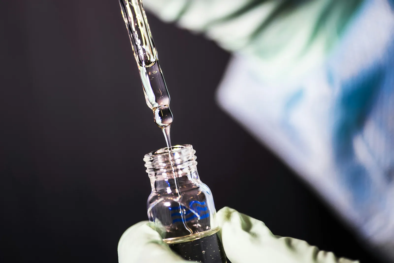 Microscope and researcher hands